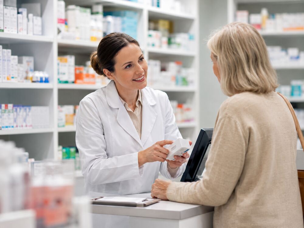 Pharmacist consulting with a patient in a community pharmacy